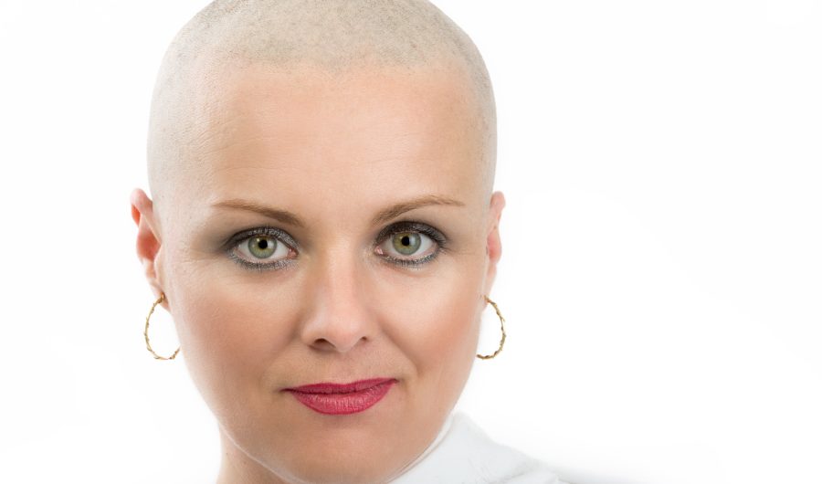 Portrait of beautiful middle age woman patient with cancer with shaved head without hair isolated on white background, hope in healing. She lost her hair